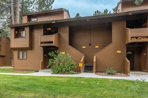 A modern multi-story building with a unique architectural design, featuring balconies and a central staircase. - Wildflower 60: Nice, Centrally Located (Mammoth Lakes)