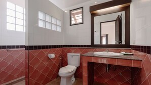 A bathroom with a toilet, sink, and mirror. - 1 Bedroom with living room and kittchenette 700meters to Rawai beach (Phuket)