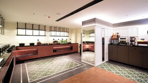A modern kitchen with a central island, built-in appliances, and a patterned floor. - SFEEL Design Hotel Hangzhou Xihu (Hangzhou)