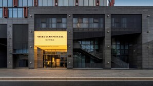 A hotel with a prominent sign reading 'Steel Design Hotel' and a modern architectural style with large windows and a staircase. - SFEEL Design Hotel Hangzhou Xihu (Hangzhou)