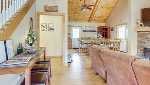 A spacious living room with a wooden ceiling, a fireplace, a dining area, and a staircase. - Sleeps 14 | Hot Tub, Game Room & 4 King Beds (Ellijay)