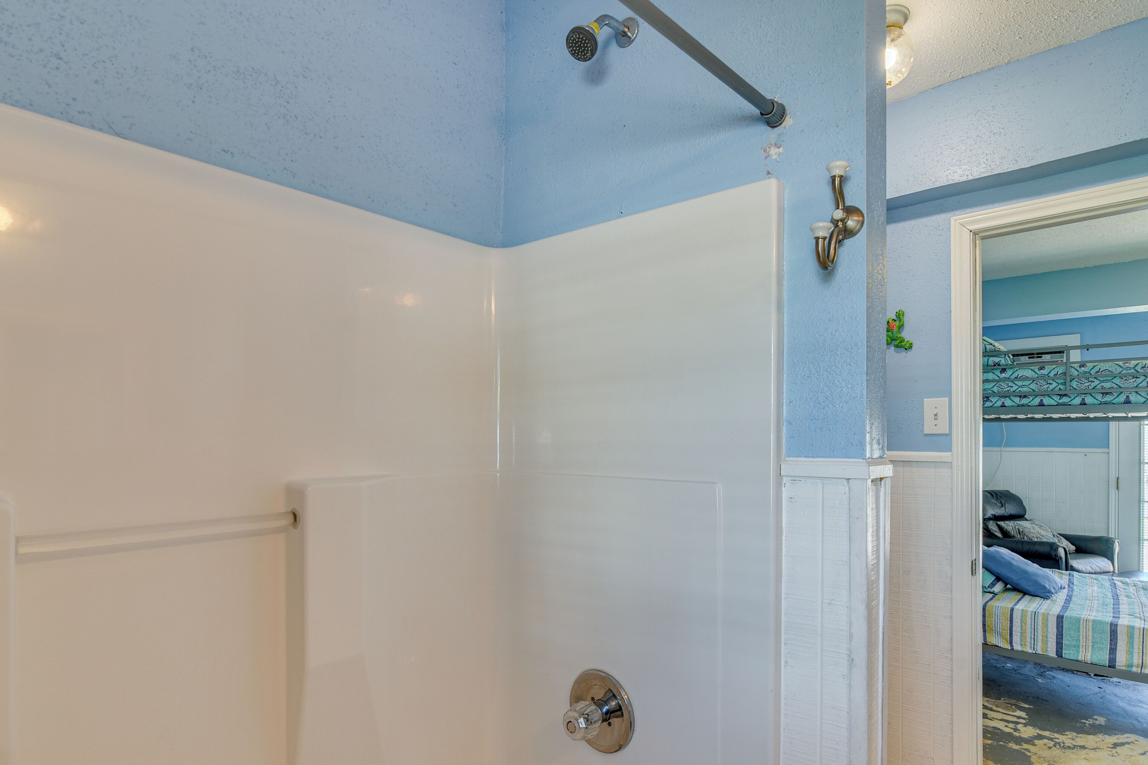 A bathroom with a shower, a toilet, and a sink.