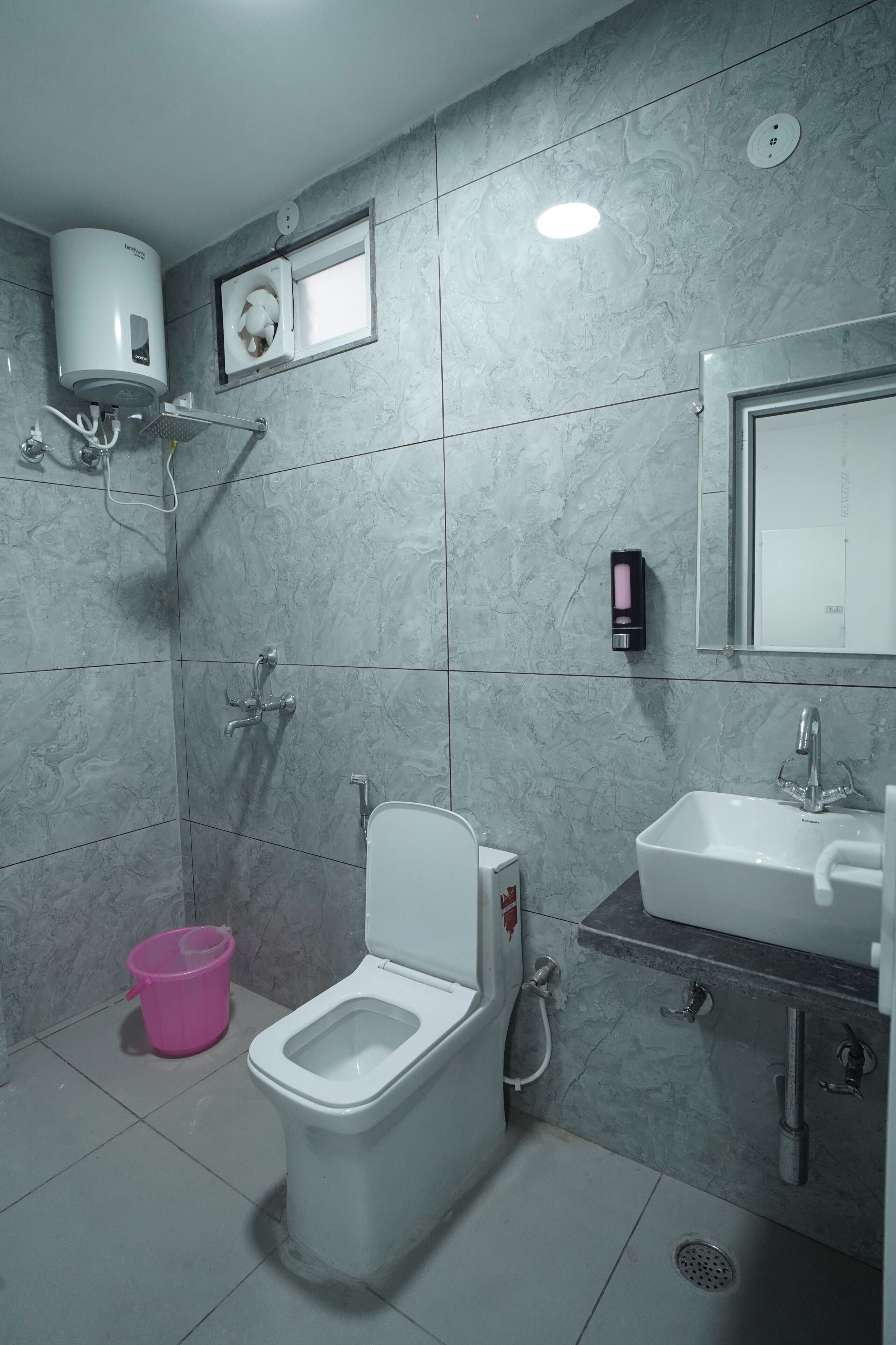 A modern bathroom with a toilet, bidet, and sink.