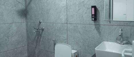 A modern bathroom with a toilet, bidet, and sink.
