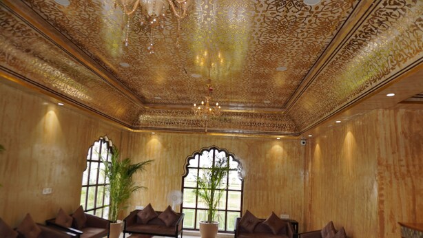 A room with ornate ceiling, large windows, and seating arrangements. - Neendar Heritage Resort (Jaipur)