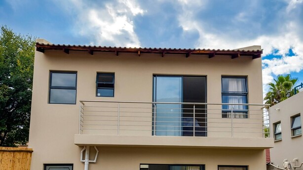 A two-story building with a balcony, a swimming pool, and a garden. - The Gracewood Sanctuary - Your Peaceful Hideaway (Johannesburg)
