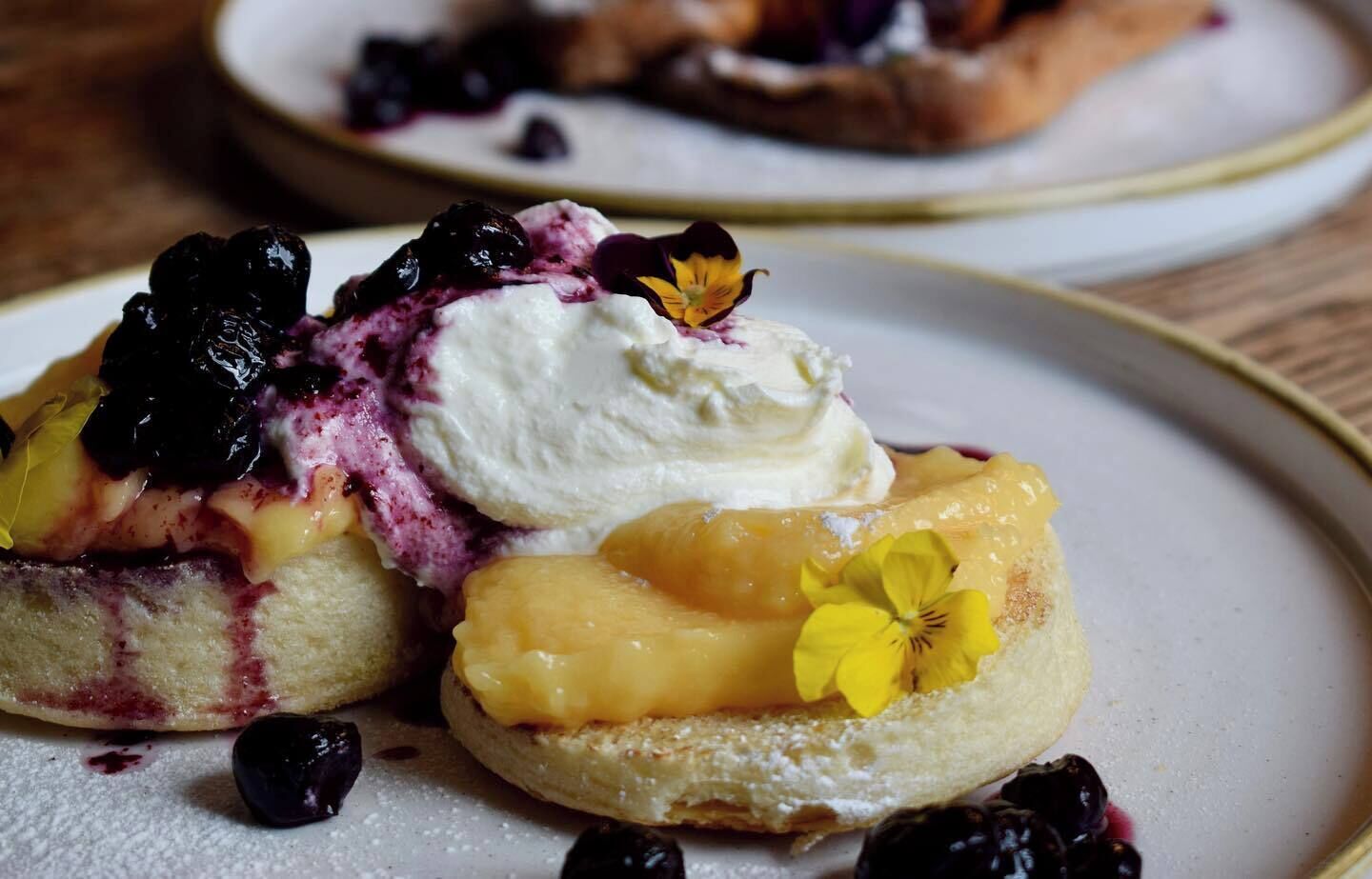 A dessert with fruit and cream on a plate.