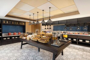 Een moderne keuken met een buffetopstelling, met diverse gerechten en drankjes.
