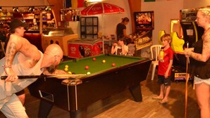 A pool table in a room with various flags, a bar area, and a poster on the wall. - COTTAGE PARKS Terrasses du Lac - Mobile home 5 persons lake view (Pont-de-Salars)