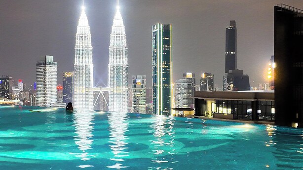 A nighttime cityscape with a prominent tower structure and a bridge. - Luxury One Bedroom Apartment with KLCC View by JD Hospitality (Kuala Lumpur)