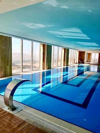Indoor pool, pool umbrellas, sun loungers. WINDYHILL HOTEL
