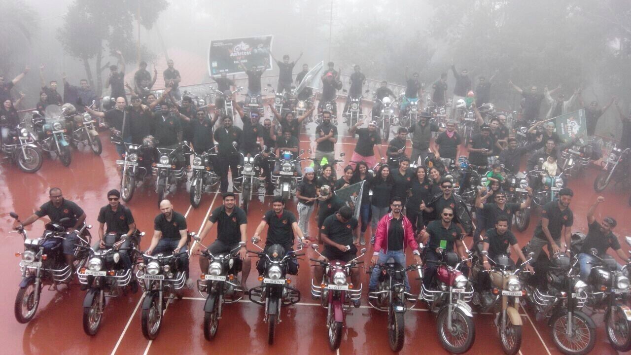 A group of people on motorcycles gathered in an open area.