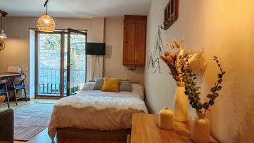 Une chambre à coucher comprenant un lit, une table de chevet et un bureau avec des chaises.