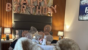 A bedroom with a bed, fluffy chairs, a 'Happy Birthday' sign, and a TV. - Room-cosy & Private Cottage With Easy ac (Pietermaritzburg)