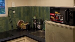 A kitchen with a microwave, a dish rack, and a sink. - Cozy studio Hoan Kiem lake/Opera House/Old quarter (Hà Nội)
