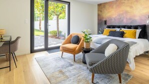 A modern bedroom with a bed, a desk, and a chair. - Ground floor room with terrace (SUCE-SUR-ERDRE)