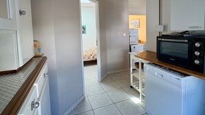 A compact kitchen with a microwave, toaster oven, and a small refrigerator. - House near sea, sunny terrace - 6 guests (Saint-Hilaire-de-Riez)