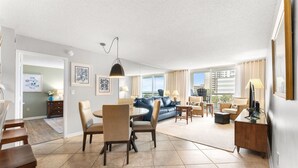 A spacious living area with a dining table, chairs, a sofa, and a TV. - S Hampton 301 2 Br Oceanview in Kingston, Pool (Myrtle Beach)