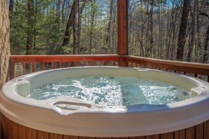 A hot tub on a wooden deck with a forest view. - WhispPineR: Wooded View, Hot Tub, Wifi, Secluded, Game Room, Theater (Sevierville)