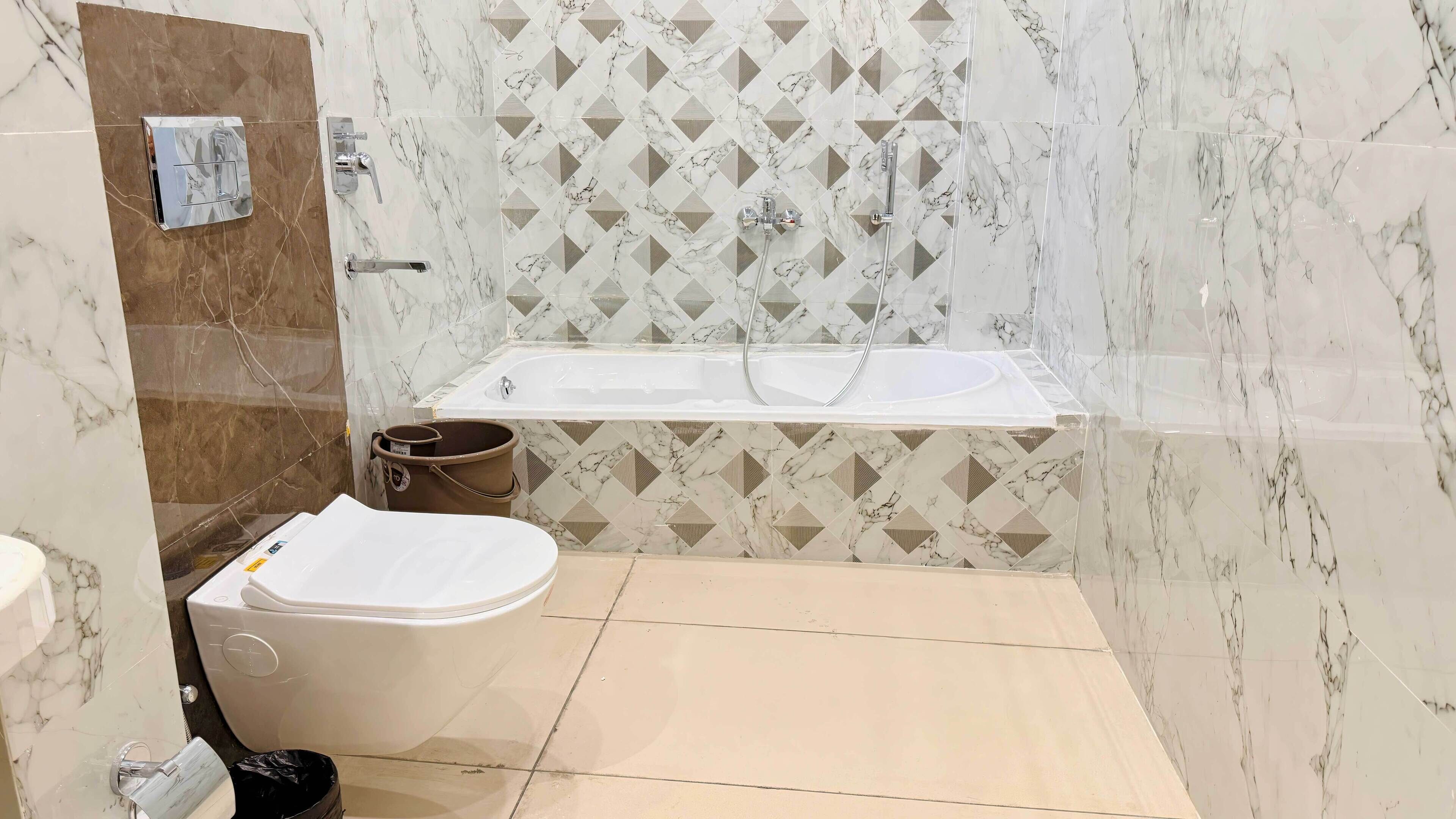 A modern bathroom with a toilet, sink, and bathtub.