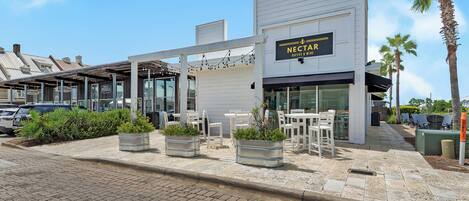 Una tienda de Nectar Coffee & Wine con terraza y macetas.