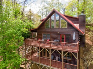 A log cabin with a deck, outdoor seating, and a chimney. - Highwood- Mountain Views, Hot Tub, Arcade, Fire Pit, Foosball, Sleeps 12 (Boone)