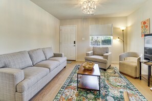A living room with a sofa, armchairs, a coffee table, a rug, a television, and a chandelier. - 2 Mi to Old Town Abq! Cozy Desert Retreat (Albuquerque)