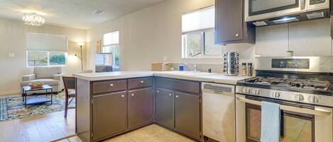 A modern kitchen with a gas stove, microwave, and dishwasher.