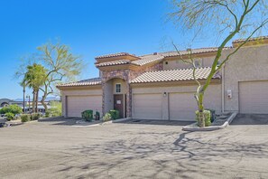A two-story house with a garage, a driveway, and a clear blue sky. - Hike & Golf in Fountain Hills! Resort-style Condo (Fountain Hills)