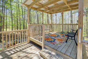 A wooden deck with a bench and a colorful rug, surrounded by a forest. - 2 Mi to Cherokee Landing! Secluded Forest Escape (Higden)