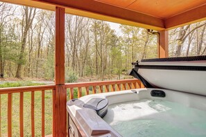 A hot tub on a wooden deck with a view of a forest. - 4 King Beds, Hot Tub, & Game Room! (Ellijay)
