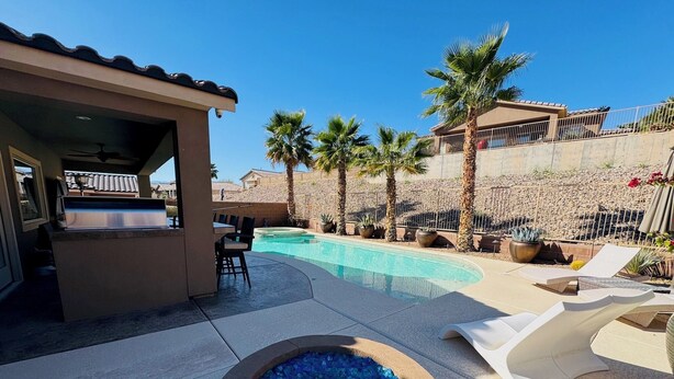 A pool area with a hot tub, lounge chairs, and a covered seating area. - Sunstone Escape | Pool + Hot Tub | 3BR | 9 Min to Sports Complex | $510 Free Activities (Mesquite)