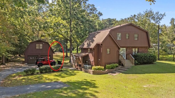 A two-story house with a garage, a covered porch, and a small shed. - Private New Bern Apartment in Quiet Neighborhood (New Bern)