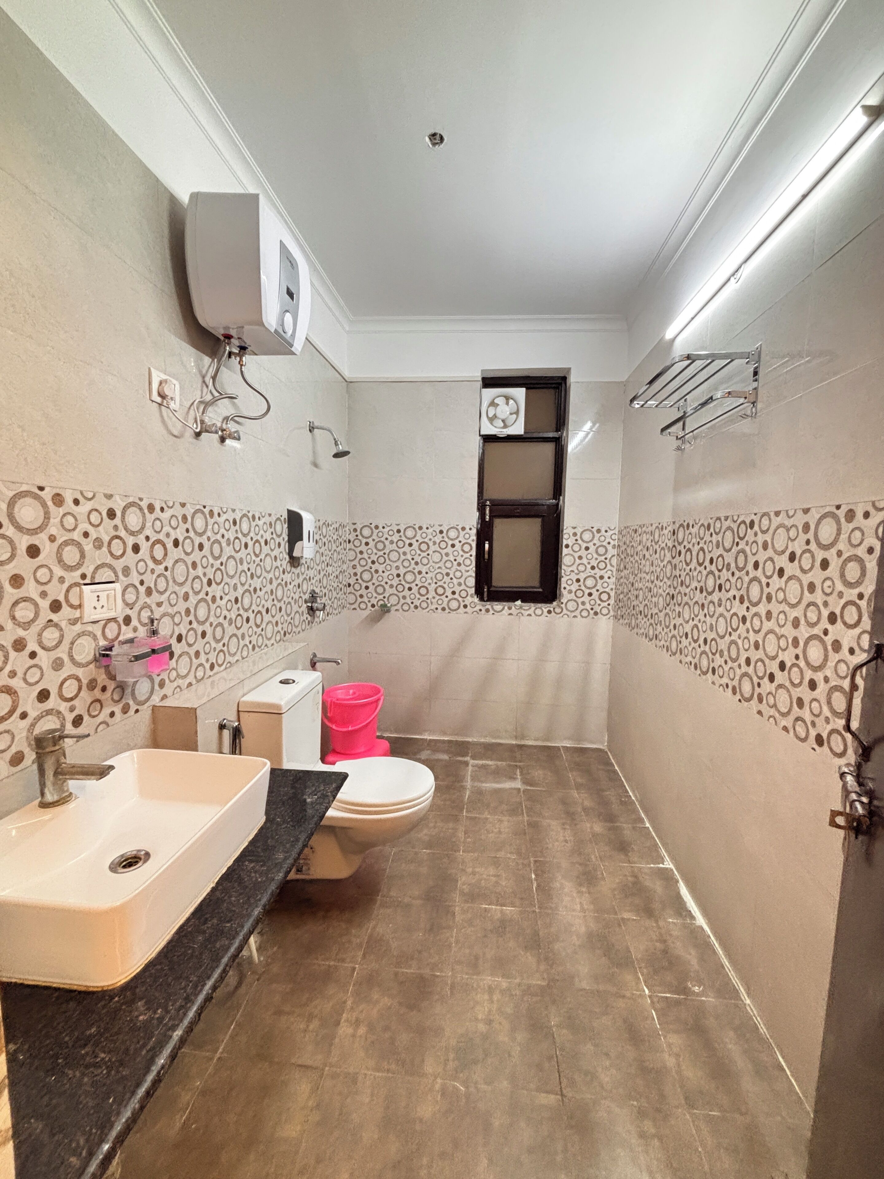 A bathroom with a sink, toilet, and shower.