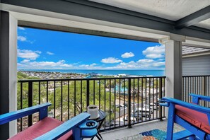 A balcony with a view of a resort area, including a pool and a water slide. - 2 BR Ocean View Condo | Myrtle Beach Resort A0527 (Myrtle Beach)