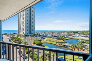 A high-rise hotel overlooking a marina with parked RVs and a body of water. - Ocean View 2 BR Condo: Myrtle Beach Resort B0546 (Myrtle Beach)