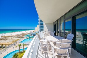 A balcony with a view of a beach and pool area. - Phoenix Gulf Shores Ii 405 4 Bedroom Condo (Gulf Shores)