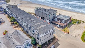 A coastal residential area with modern buildings, a beach, and ocean views. - Eazy Breezy: Ocean Views, Dog-Friendly Rockaway Beach Townhome for 8 (Rockaway Beach)
