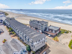 A coastal residential area with modern buildings, a beach, and ocean views. - Eazy Breezy: Ocean Views, Dog-Friendly Rockaway Beach Townhome for 8 (Rockaway Beach)