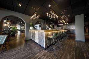 A modern bar area with a central counter, bar stools, and pendant lighting. - Active Dutch Getaway with Cycling Routes, Pool Access and Free Parking (Winterswijk)