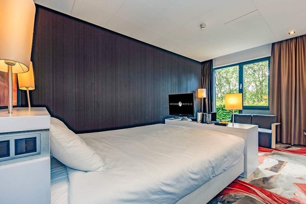 Sink into plush bedding and gaze out at calming greenery.