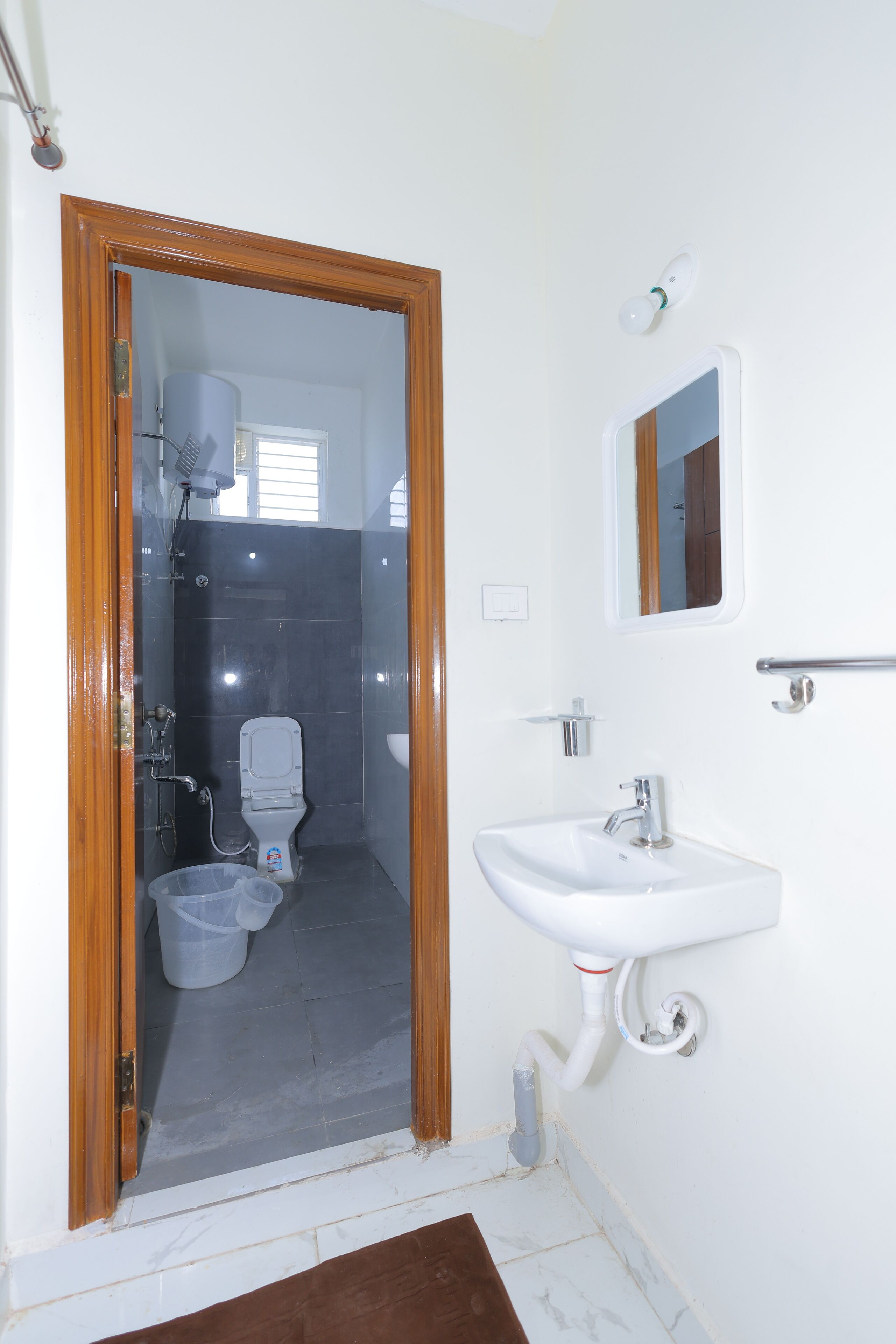 A bathroom with a toilet, sink, and shower.