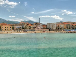 A coastal town with buildings along the beach, clear skies, and calm sea. - Le Dimore di Santa Costanza by Interhome (San Vincenzo)