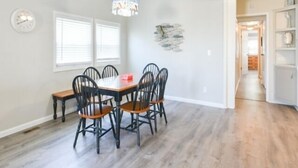 A dining area with a wooden table and chairs, a chandelier, and a clock on the wall. - 3 BR 2 BA located in the Montego Bay Community, 2 Pools Tennis. Pets welcome (Ocean City)