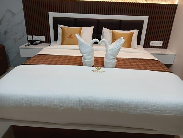 A hotel room with a bed, two nightstands, a telephone, and a decorative pillow.