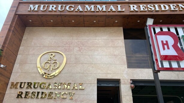 A building with a sign that reads 'MURUGAMMAL RESIDENCY' and a logo with 'RGP' in the center. - Murugammal Residency (Tirupattur)