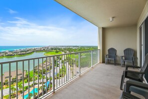 A balcony with a view of a body of water, chairs, and a pool. - ☀️Walk to Beach | Gulf Views | 3 Pools | Ariel Dunes II 1507☀️ (Miramar Beach)