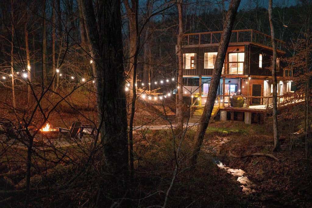 Exterior: Enchanting evenings by the fire with twinkling lights and serene woodland views!