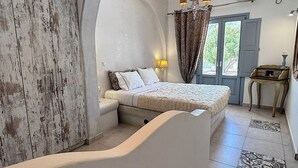 A bedroom with a bed, a nightstand, a lamp, a dresser, and a window with curtains. - Villa Galathea (Episkopi Gonias)