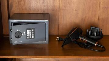 A safe with a keypad and a decryption device on a wooden surface.